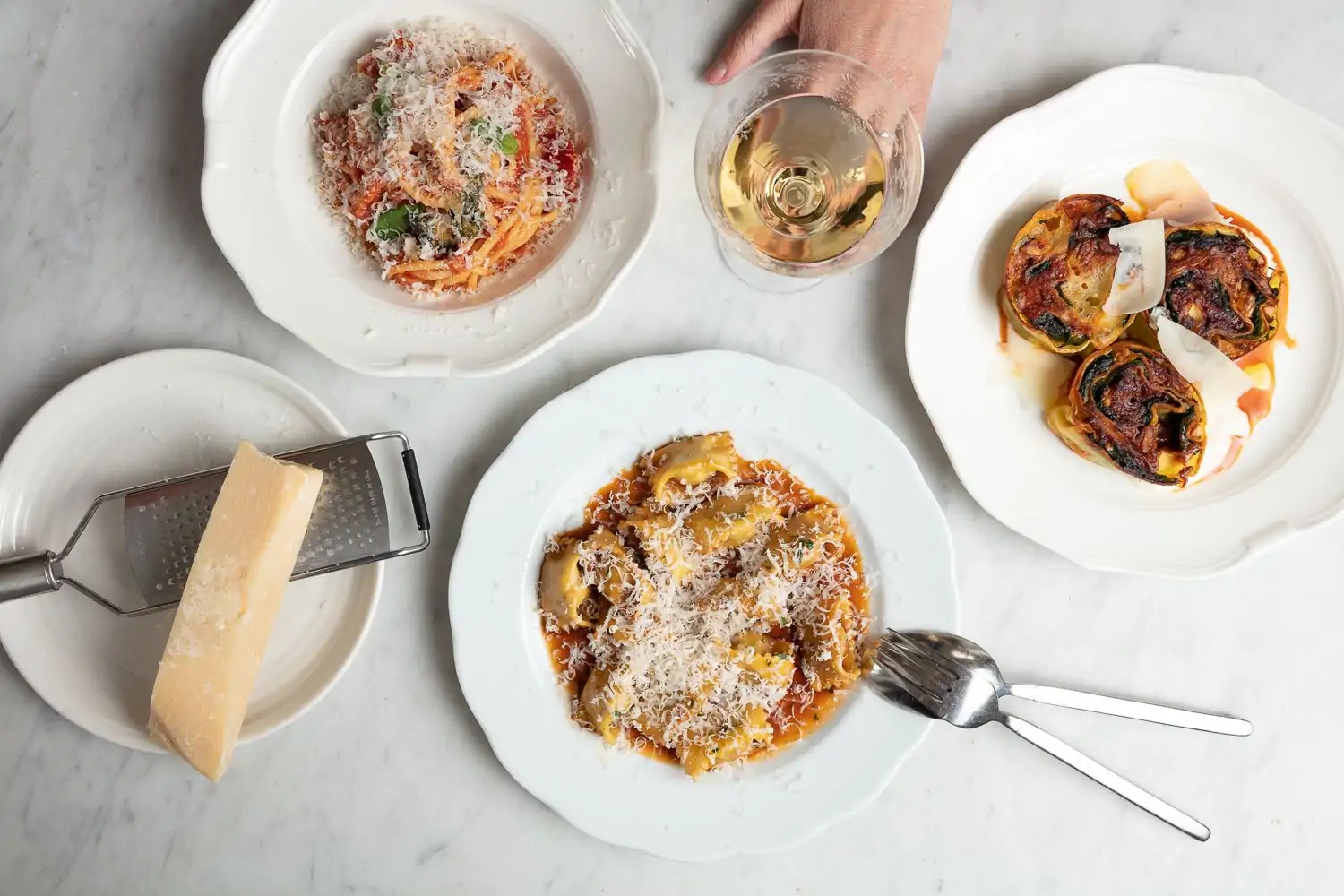An overhead view of Italian food and wine from The Tailor’s Son, in San Francisco. Book on OpenTable.