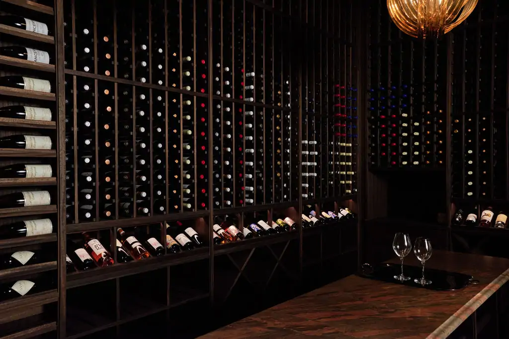 Several bottles of wine stacked in a wine wall at Chicago restaurant The Alston