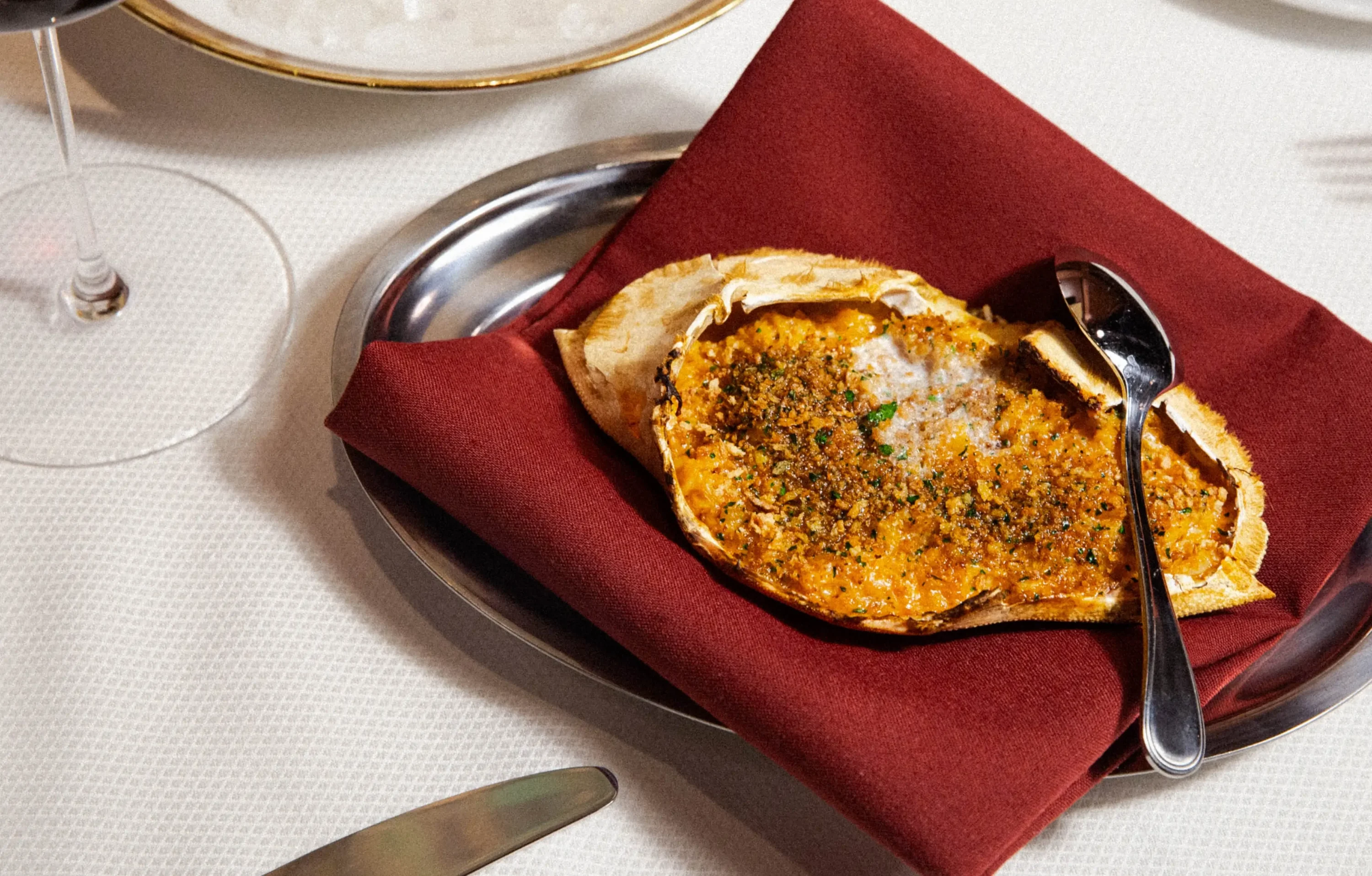 A baked crab dish at NYC restaurant Chez Fifi