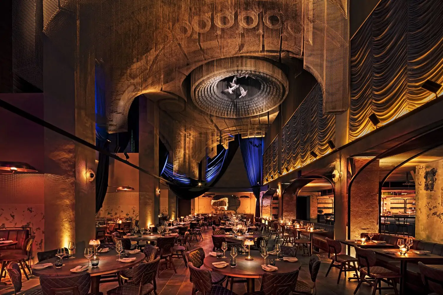 Set tables in the dramatically cavernous Cathédrale, one of the best hotel restaurants in NYC, on OpenTable.