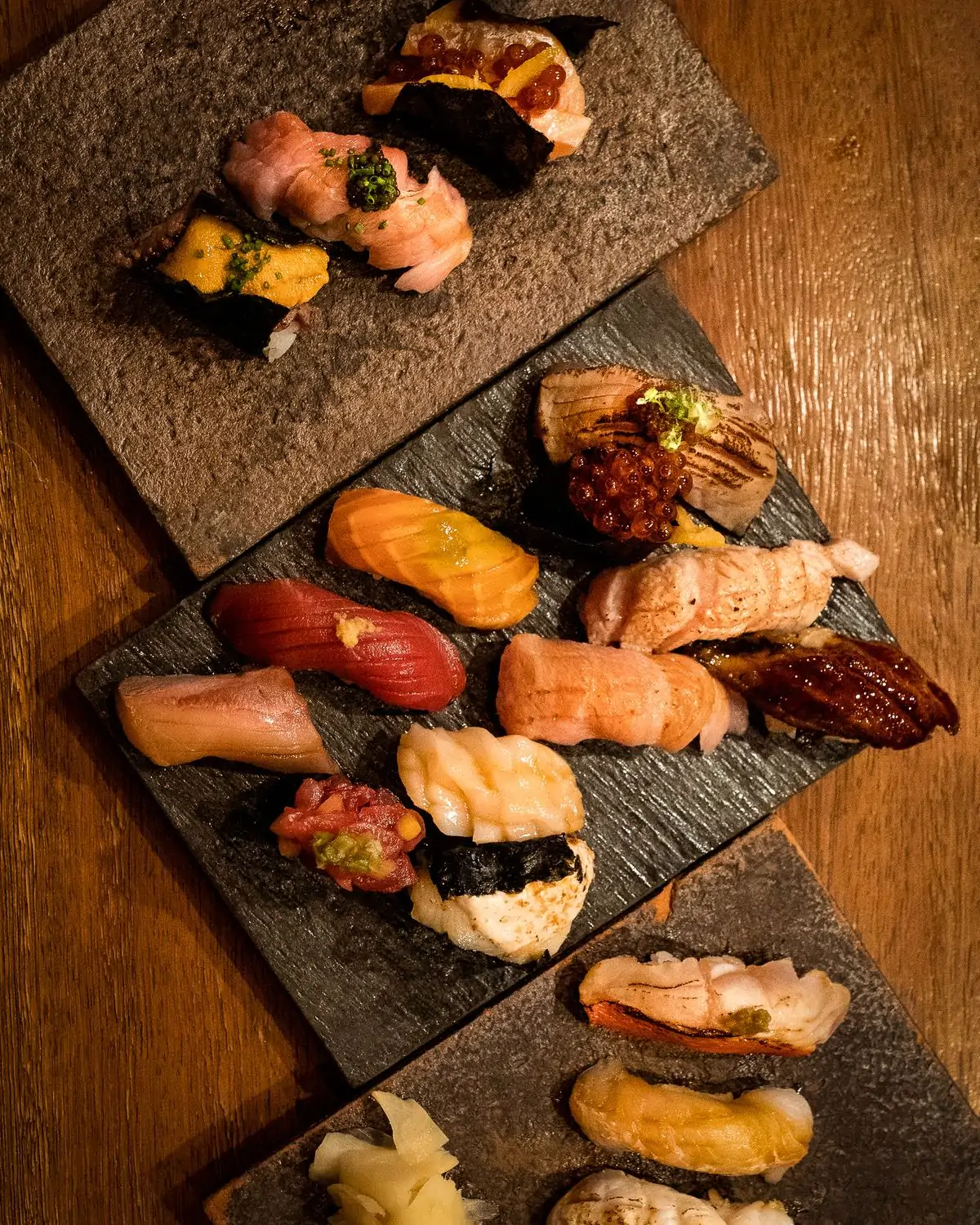 A variety of nigiri on three platters at Sushi by Bou, a NYC best hotel restaurant on OpenTable.