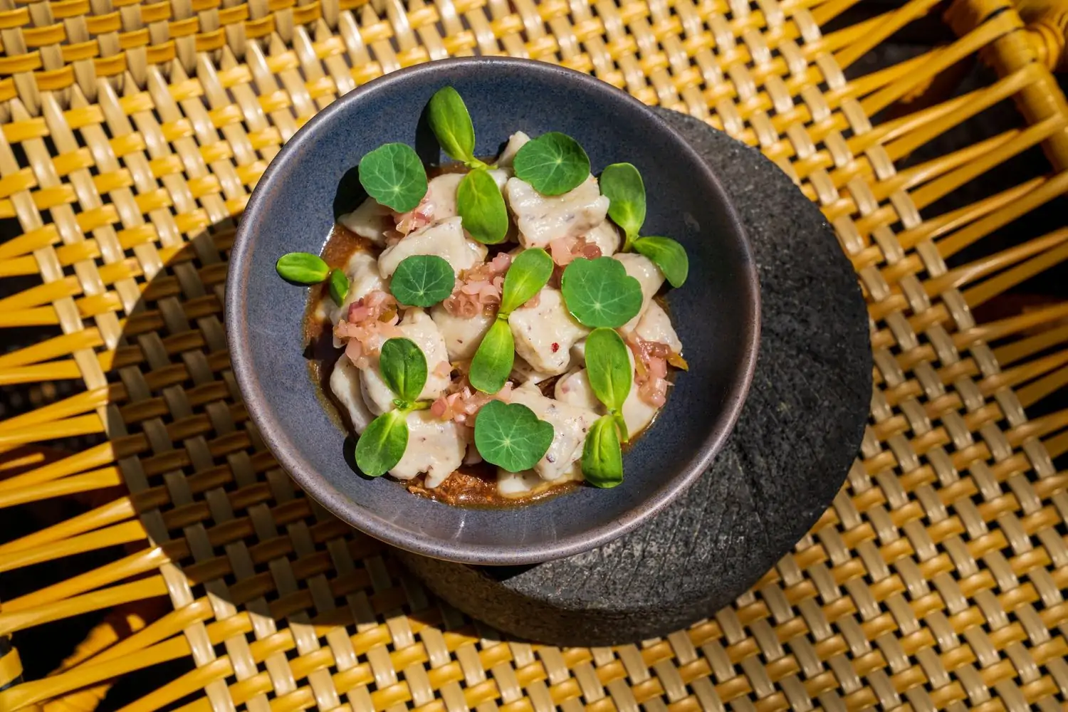 A bowl of seafood with garnish at Los Félix, one of the best restaurants in Coconut Grove, Miami, for eco-conscious invitees. Book on OpenTable.