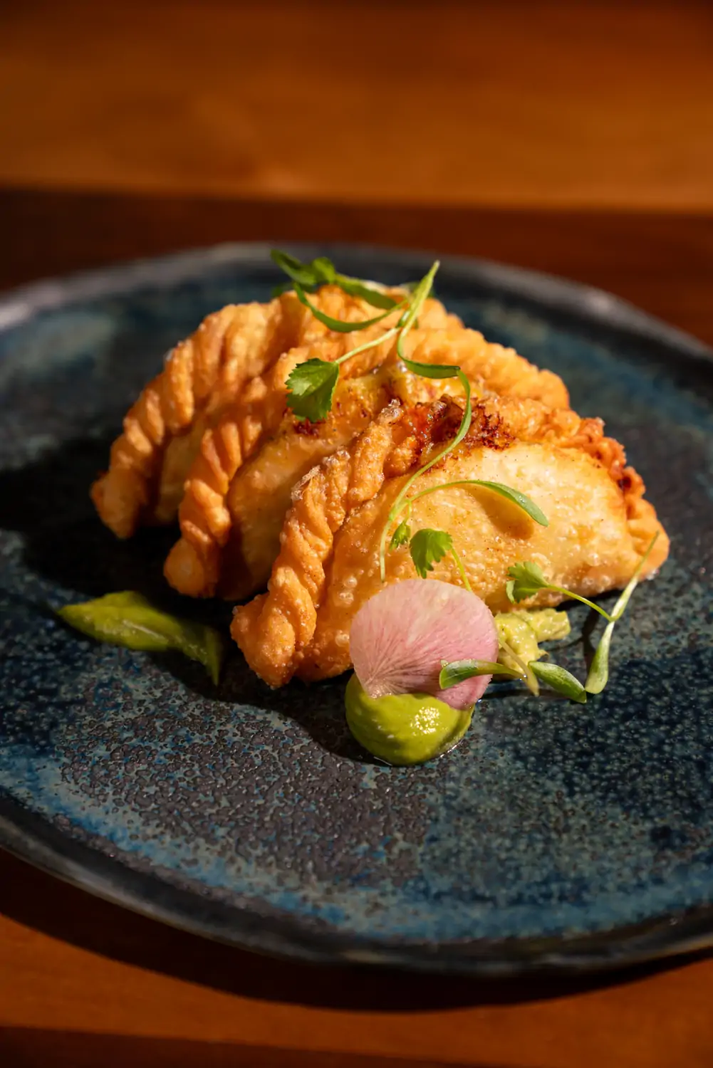 Crispy empanadas with garnishes at Toro by Chef Richard Sandoval in Chicago. Book on OpenTable.
