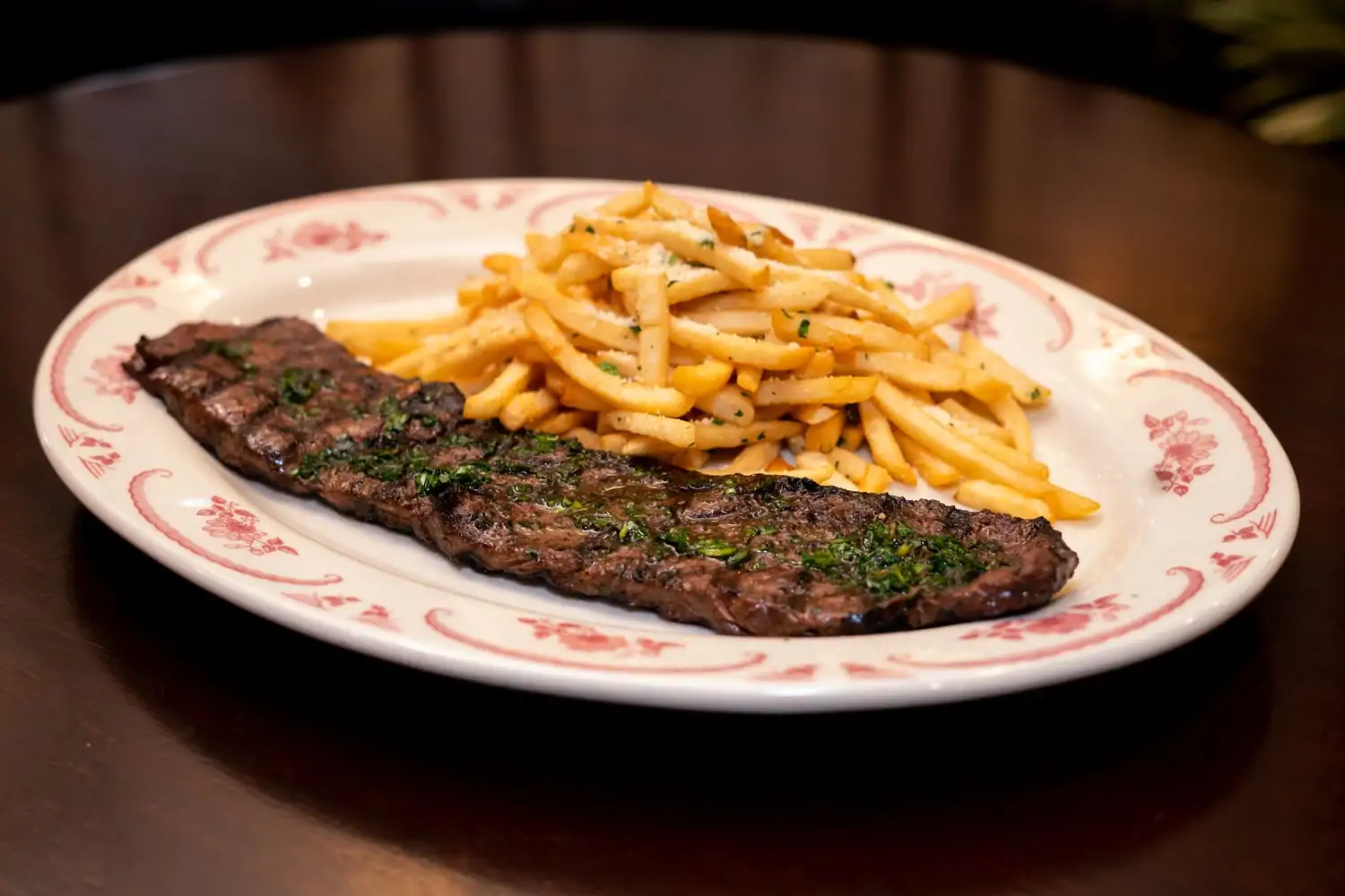 A steak with chimichurri sauce and fries at Petterino’s, in Downtown Chicago. Reserve on OpenTable.
