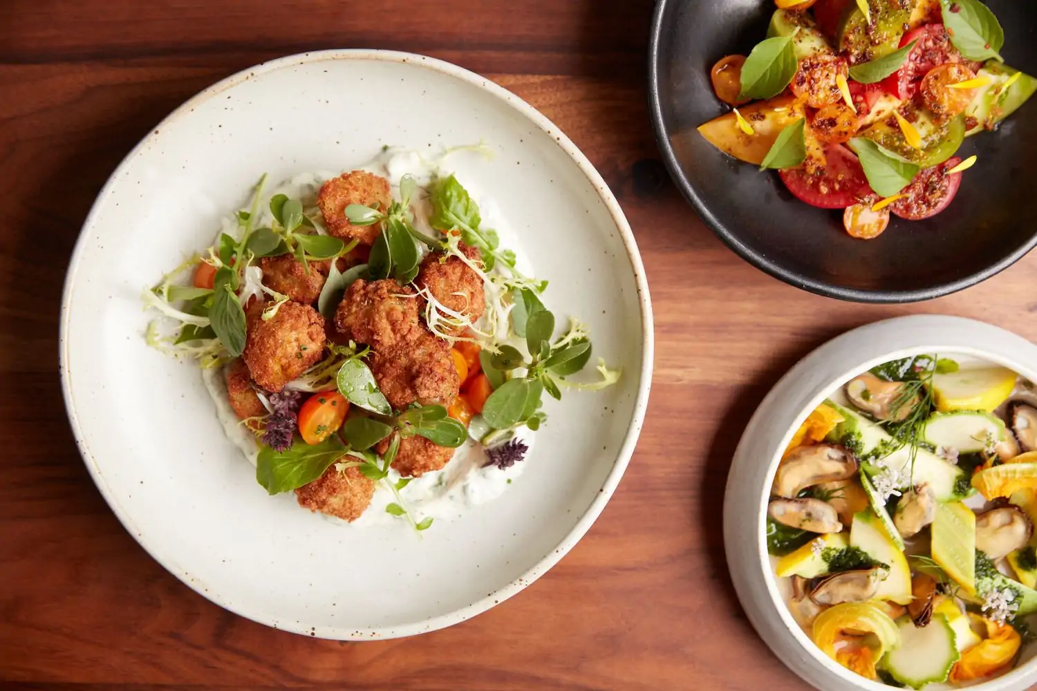 An overhead view of dishes from Frances, one of the best restaurants in Castro, San Francisco. Book on OpenTable.