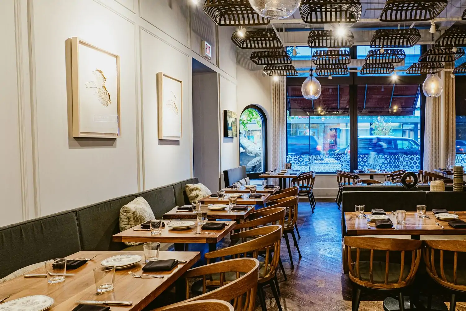 The interior of Chicago restaurant Virtue with windows looking out on the street