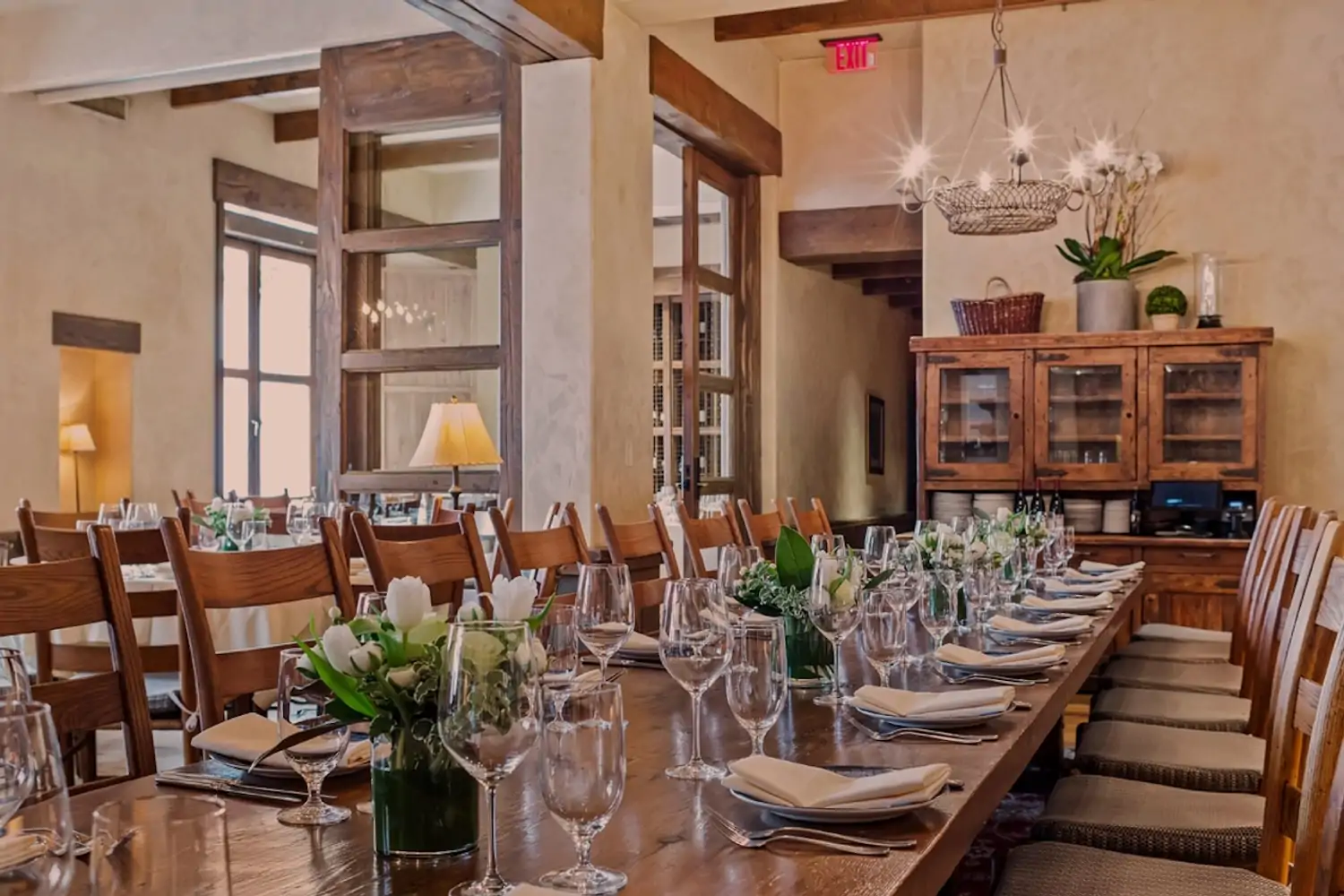 The interior of San Francisco restaurant Kokkari Estiatorio with wooden tables and chairs