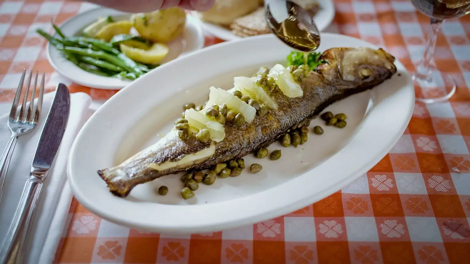 A whole baked fish with capers at Grand Central Oyster Bar in NYC, available on OpenTable.
