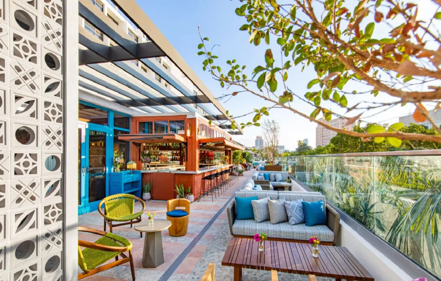 An outdoor bar and seating area with Miami's skyline at Serena Rooftop, one of the best Miami rooftop restaurants, on OpenTable.