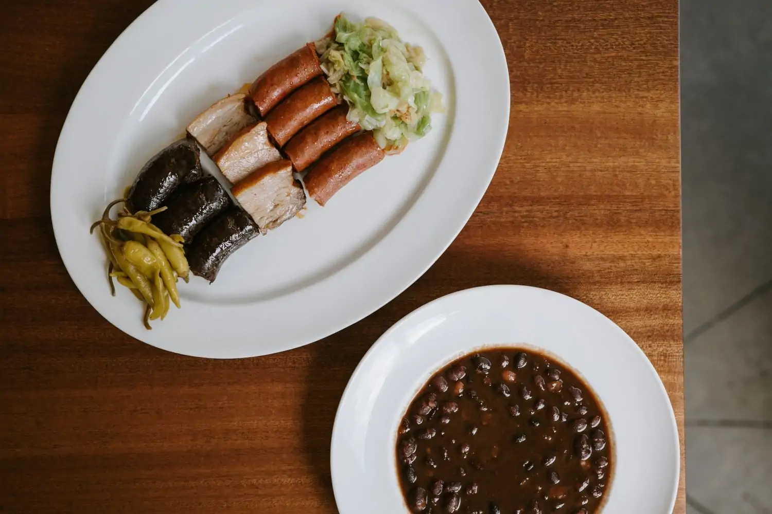 Aerial view of Spanish grilled meat and bean dishes at Ernesto’s, one of the best Spanish restaurants in NYC. Book on OpenTable.