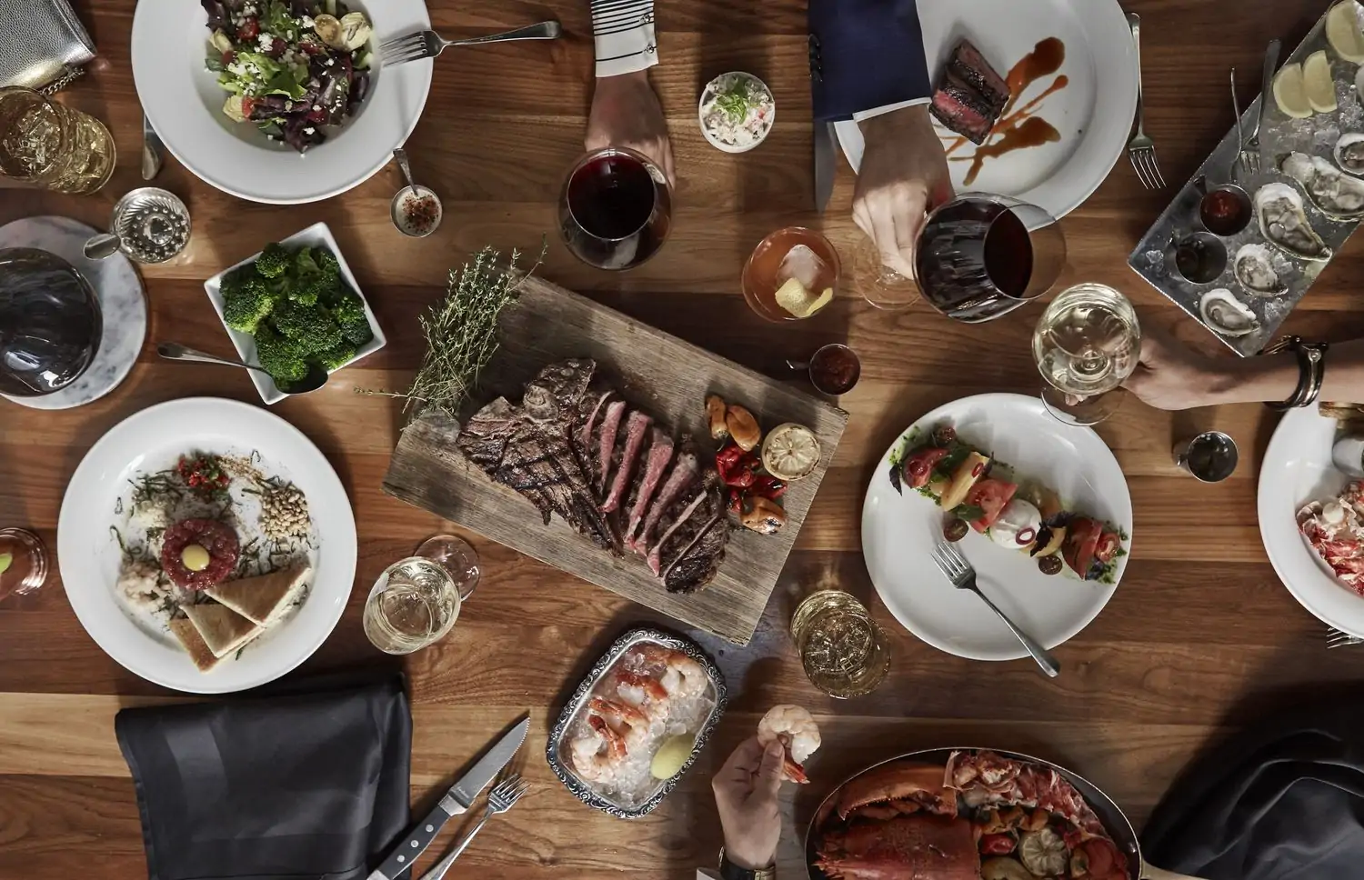 teak by Michael Mina ALT text: Overhead view of dishes from Bourbon Steak in Miami, available on OpenTable.