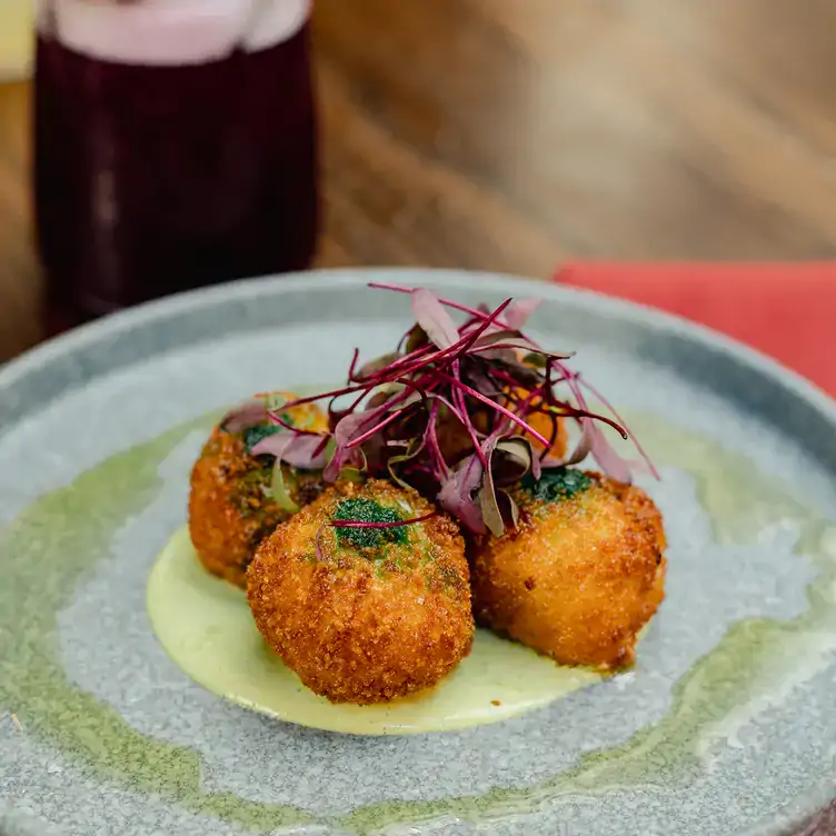 Starter dish on blue plate at Alma Cocina