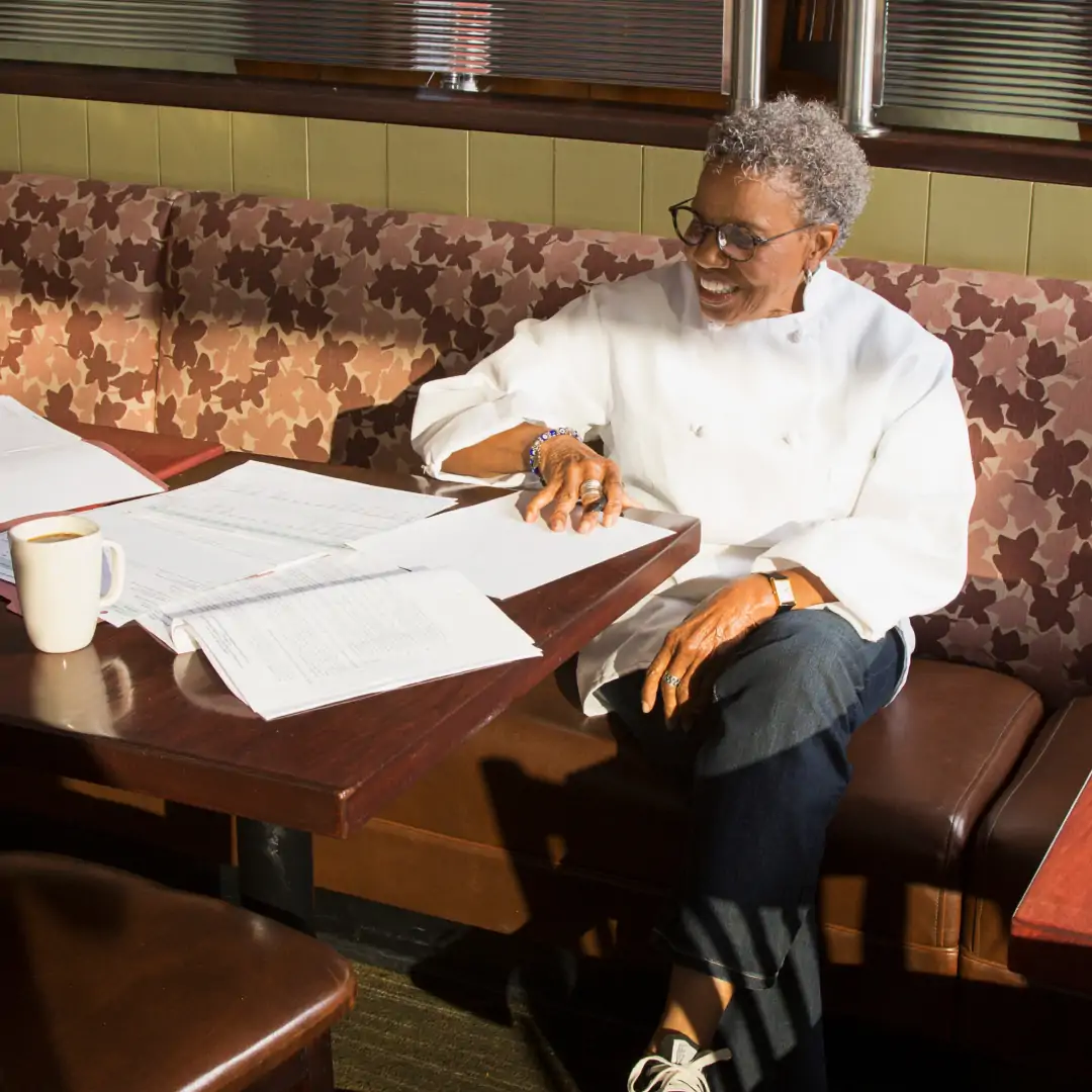 restaurant owner doing paperwork in a restaurant table