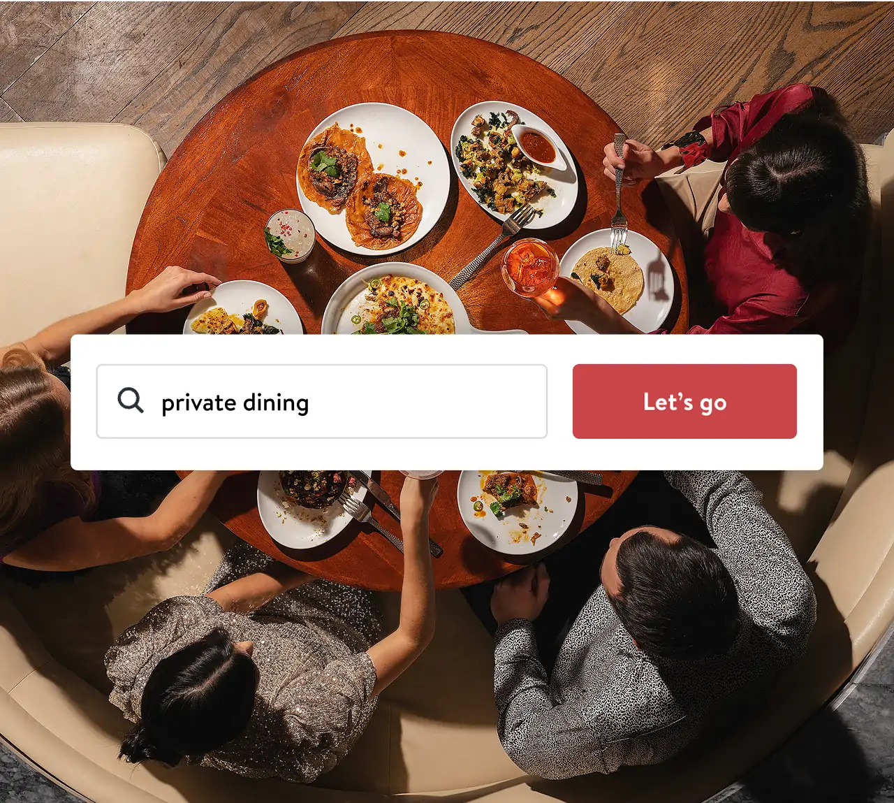 Friends sharing a meal at a round table, illustrating a private dining experience being searched for