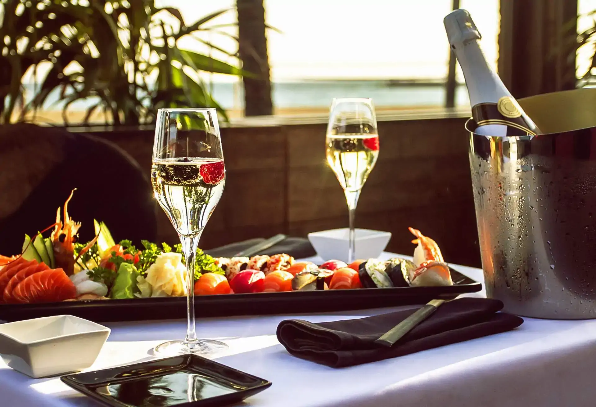 An elegant table setting with champagne and appetizers, illustrating the different types of upscale private dining experiences discussed in the article.
