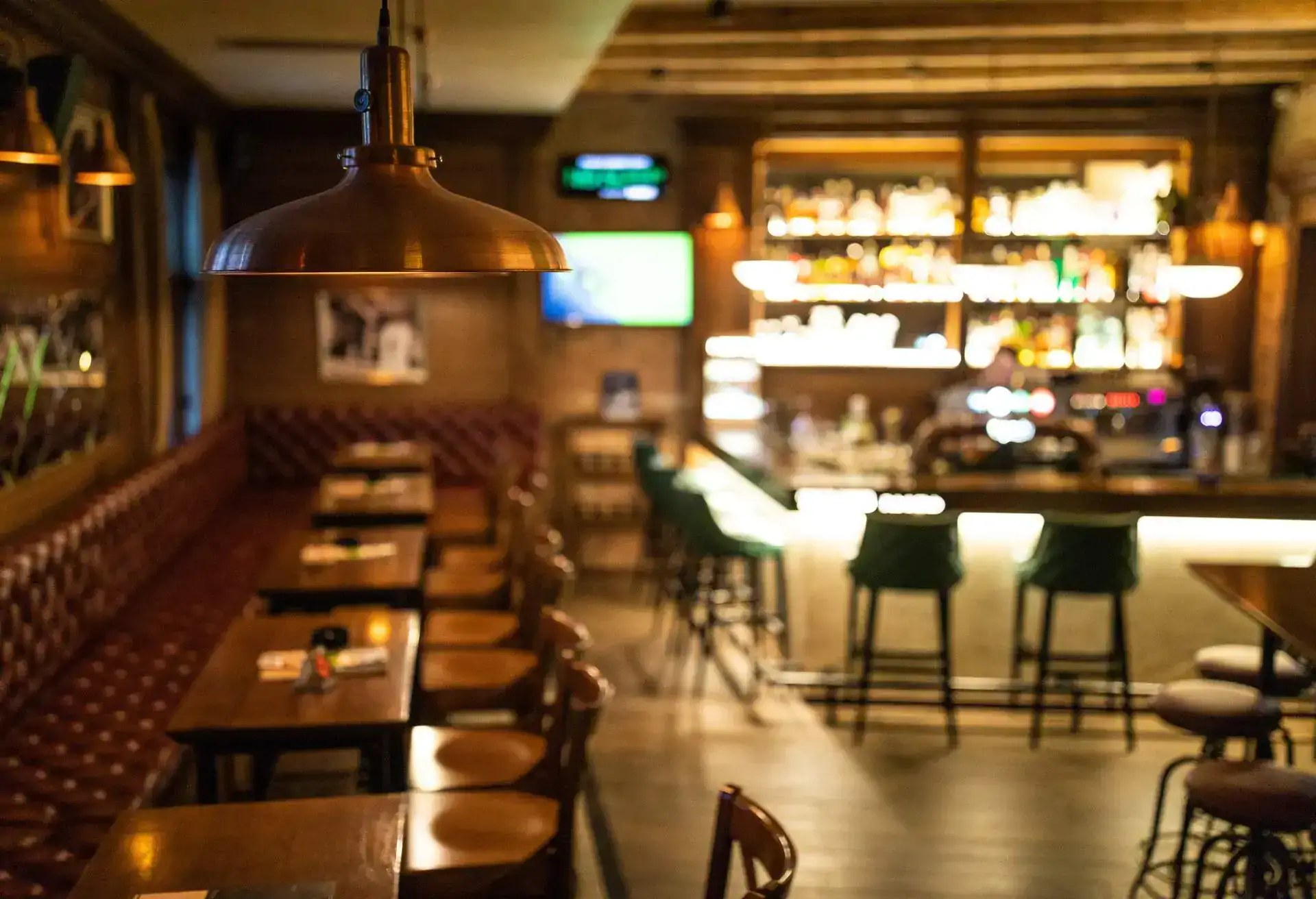 Interior of a classic restaurant with a bar and dining booths, representing spaces discussed in the comprehensive guide to private dining rooms.